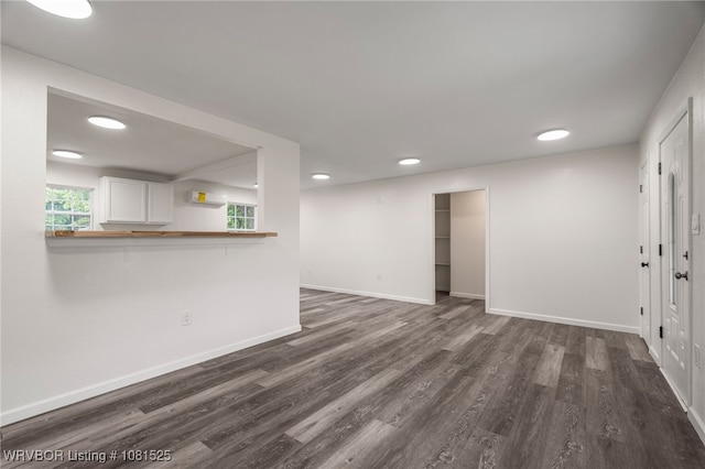 2308 N 50th St, Fort Smith, AR 72904 - unfurnished living room featuring dark wood-style flooring, baseboards, and recessed lighting