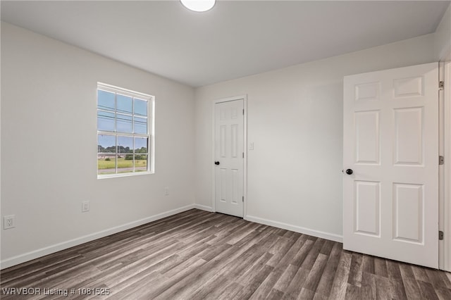 2308 N 50th St, Fort Smith, AR 72904 - unfurnished bedroom featuring dark wood finished floors and baseboards