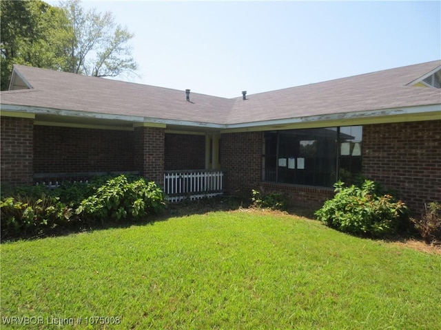 rear view of house with a yard