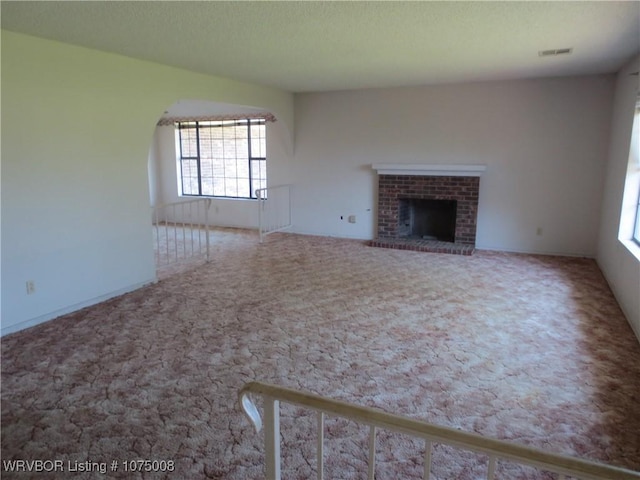 unfurnished living room featuring a fireplace