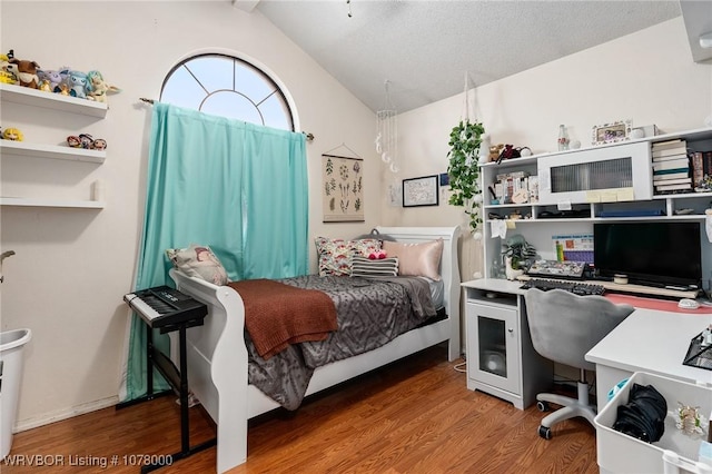 bedroom with hardwood / wood-style floors and vaulted ceiling