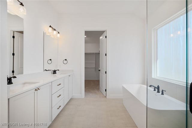 7627 Woodbine Ln, Fort Smith, AR 72916 - bathroom featuring a soaking tub, double vanity, and a walk in closet