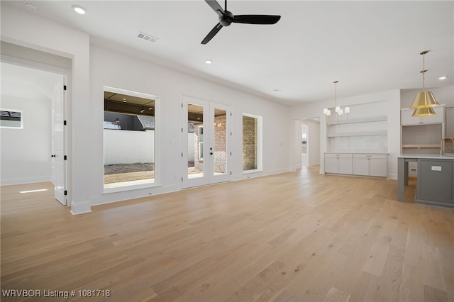 7627 Woodbine Ln, Fort Smith, AR 72916 - unfurnished living room featuring a ceiling fan, light wood-type flooring, recessed lighting, a chandelier, and french doors