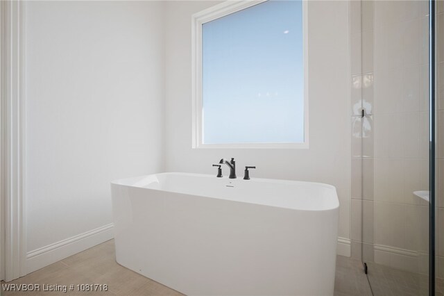 7627 Woodbine Ln, Fort Smith, AR 72916 - full bathroom featuring a freestanding bath, a shower stall, and wood finished floors