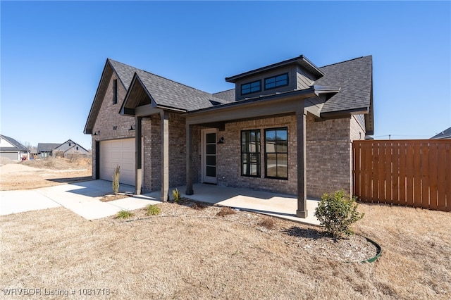7627 Woodbine Ln, Fort Smith, AR 72916 - view of front facade featuring concrete driveway, brick siding, a garage, and roof with shingles