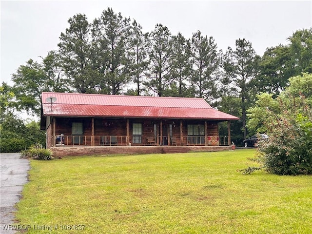 710 E 4th St, Hartford, AR 72938 - view of front facade featuring metal roof, a front lawn, and a porch