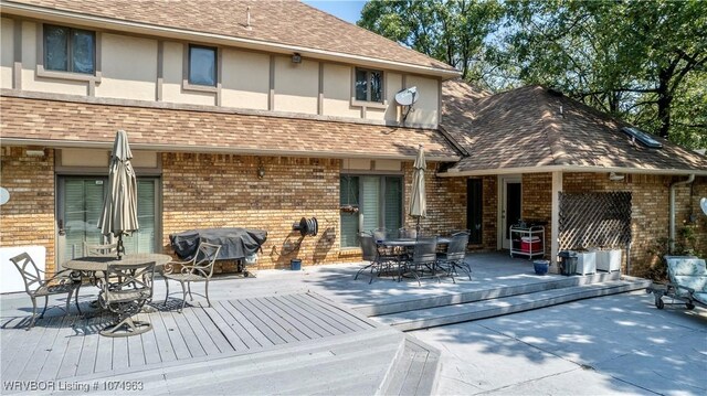 back of property with a wooden deck