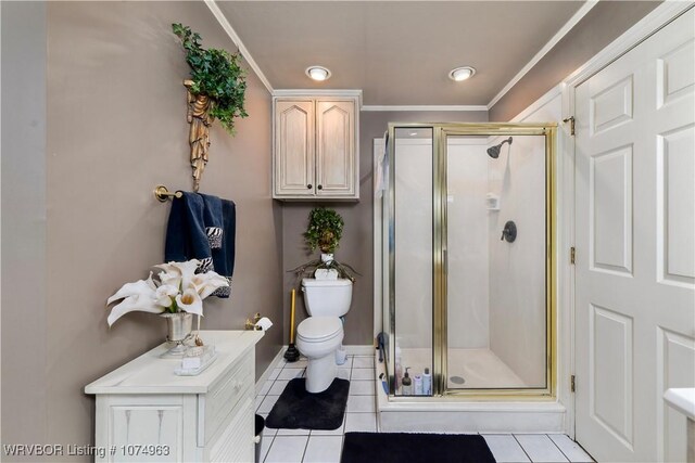 bathroom featuring tile patterned flooring, toilet, a shower with shower door, and crown molding