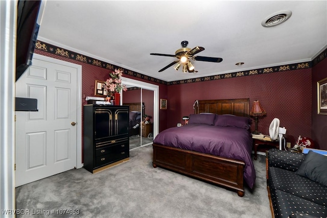 bedroom featuring carpet flooring, a closet, ceiling fan, and ornamental molding