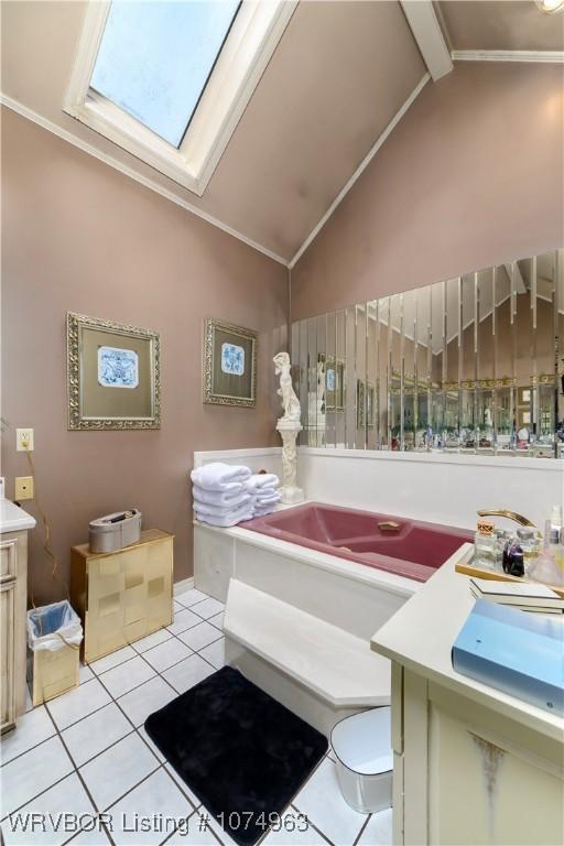 bathroom with tile patterned floors, vanity, and vaulted ceiling