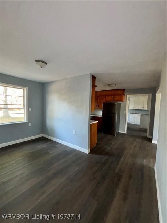 unfurnished living room featuring dark wood-type flooring