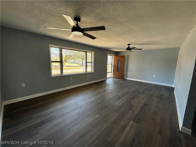 spare room featuring ceiling fan, dark hardwood / wood-style floors, and a textured ceiling