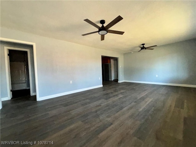 spare room with ceiling fan and dark hardwood / wood-style flooring