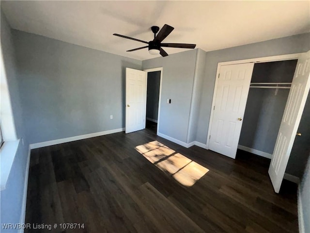 unfurnished bedroom with ceiling fan, dark hardwood / wood-style floors, and a closet