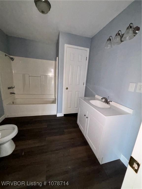 full bathroom featuring vanity, wood-type flooring, toilet, and shower / bathing tub combination