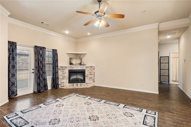 unfurnished living room featuring a fireplace, dark hardwood / wood-style floors, ceiling fan, and ornamental molding