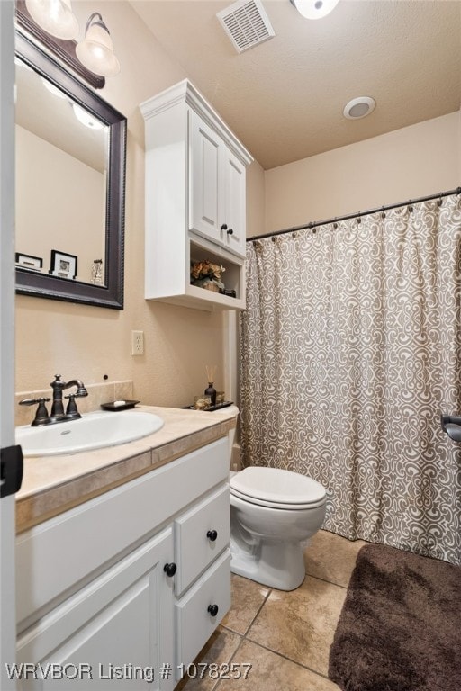 bathroom with tile patterned floors, vanity, and toilet