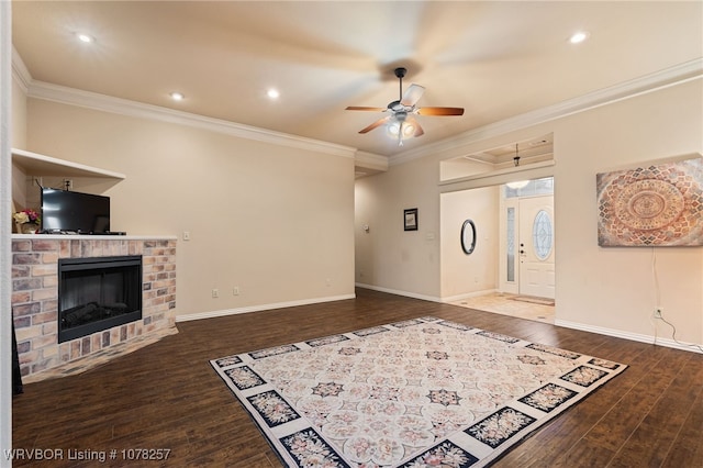 living room featuring a brick fireplace, ceiling fan, dark hardwood / wood-style flooring, and ornamental molding