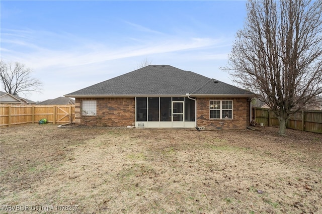 rear view of property featuring a sunroom