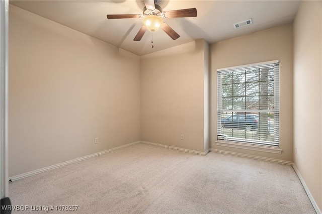 carpeted spare room with ceiling fan