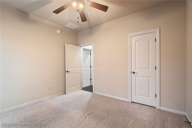 unfurnished bedroom with ceiling fan and light carpet