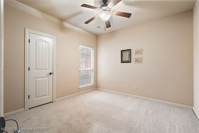 carpeted empty room featuring ceiling fan