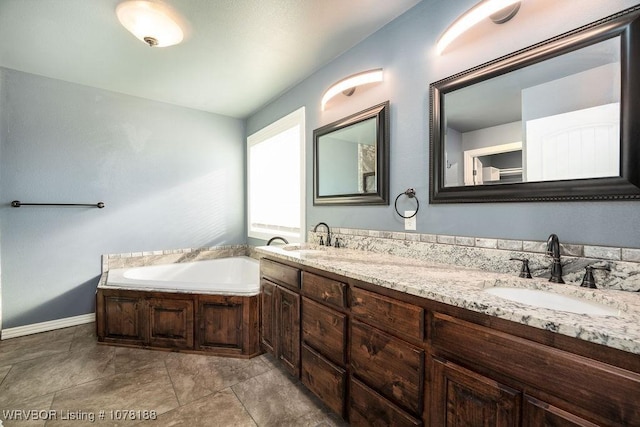 bathroom with a tub to relax in and vanity