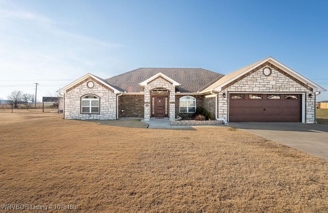 ranch-style home with a front yard and a garage