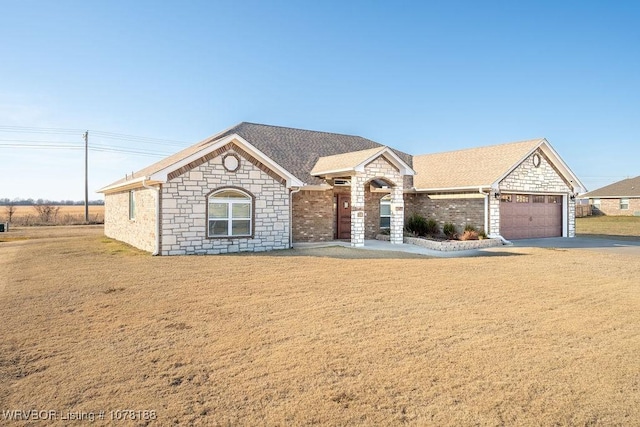 view of front of home with a garage and a front lawn