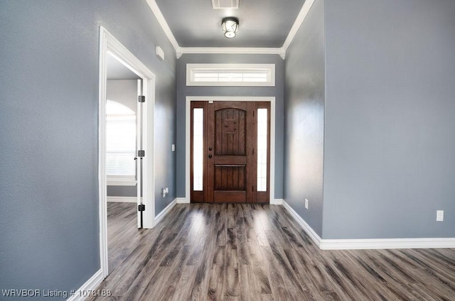 entryway with dark hardwood / wood-style flooring and ornamental molding