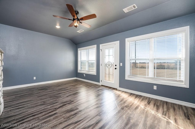 foyer with dark hardwood / wood-style floors, vaulted ceiling, and ceiling fan