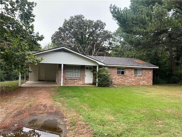 ranch-style house with a front lawn and a carport