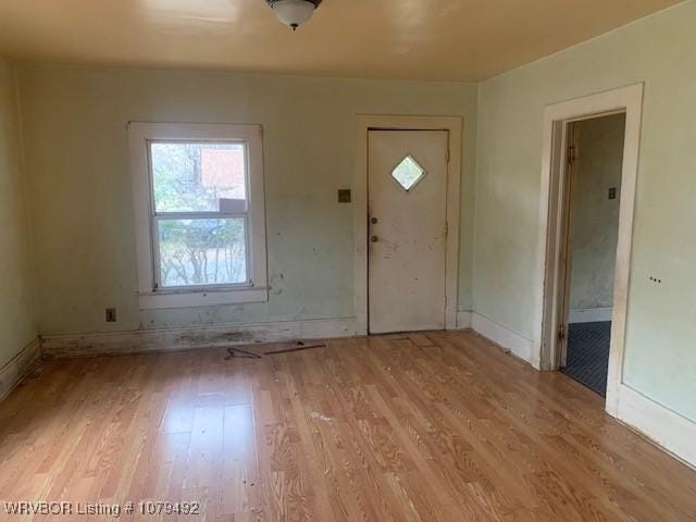 foyer with baseboards and light wood-type flooring