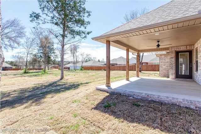 view of yard with fence, a ceiling fan, and a patio area