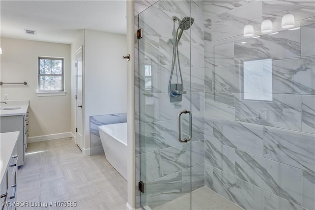 full bath featuring visible vents, a soaking tub, a shower stall, baseboards, and vanity