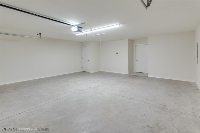garage with a garage door opener and baseboards