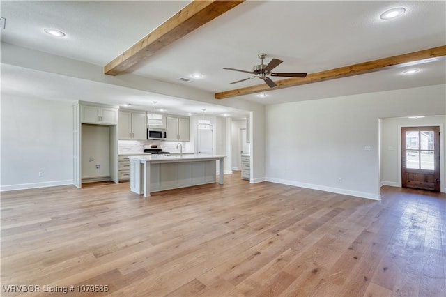 unfurnished living room with light wood-style flooring, baseboards, beamed ceiling, and ceiling fan