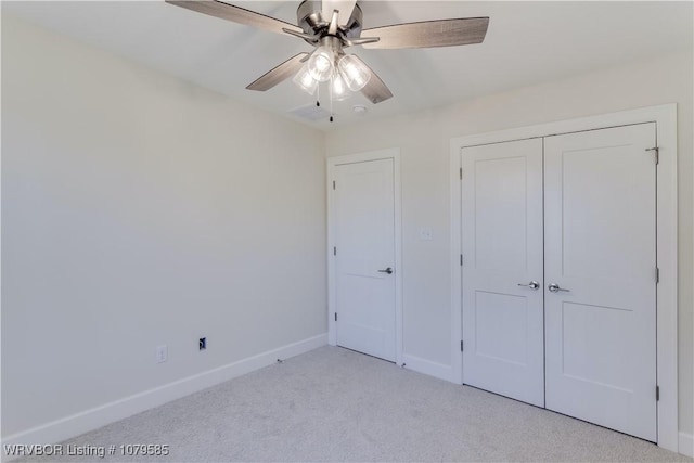 unfurnished bedroom with baseboards, a closet, a ceiling fan, and light carpet