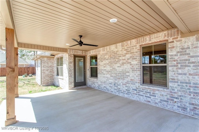 view of patio / terrace with ceiling fan and fence