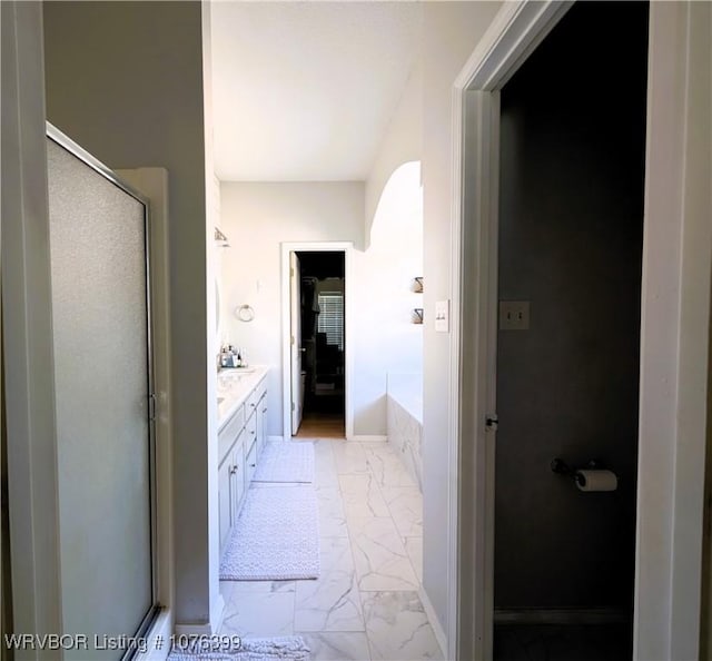 bathroom with vanity and shower with separate bathtub