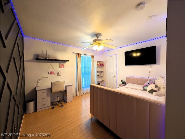 bedroom with light hardwood / wood-style flooring and ceiling fan