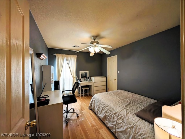 bedroom with ceiling fan and light hardwood / wood-style flooring