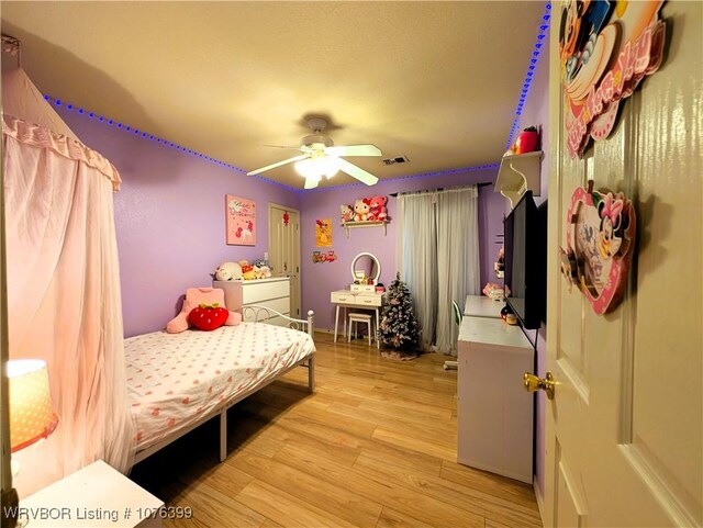 bedroom featuring ceiling fan and light hardwood / wood-style flooring