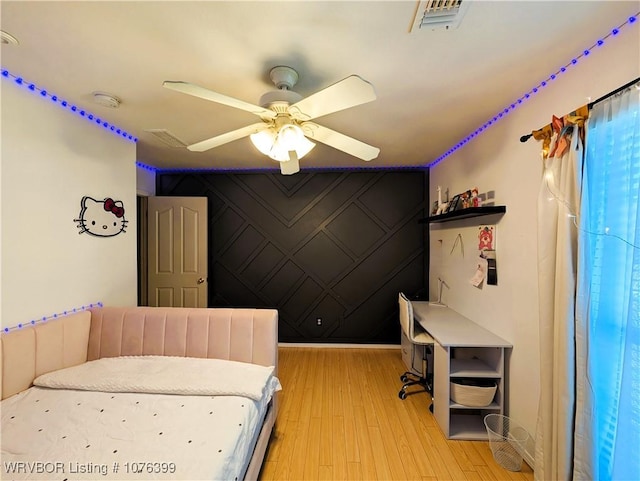 bedroom with light hardwood / wood-style floors and ceiling fan