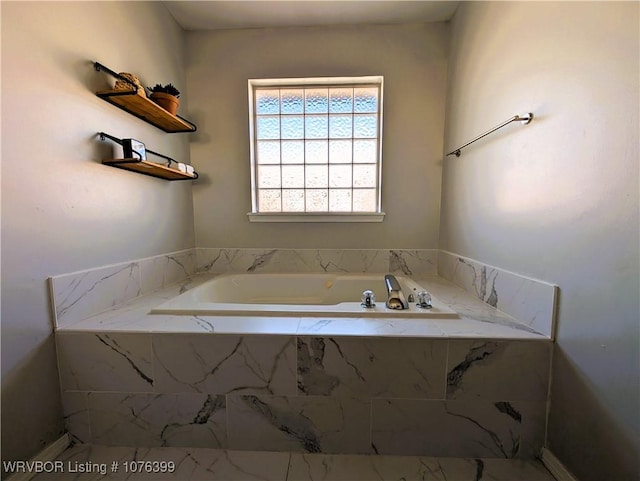 bathroom featuring tiled tub