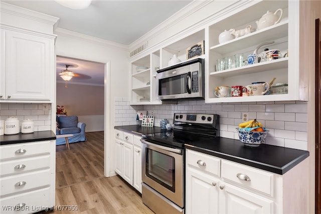 kitchen featuring decorative backsplash, white cabinetry, ornamental molding, and appliances with stainless steel finishes