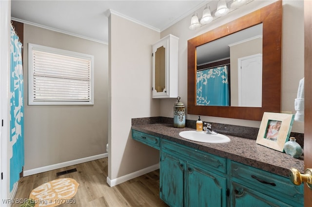 bathroom with wood-type flooring, vanity, toilet, and crown molding