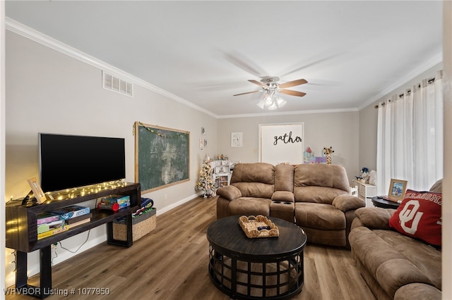 living room with dark wood-type flooring, ceiling fan, and crown molding