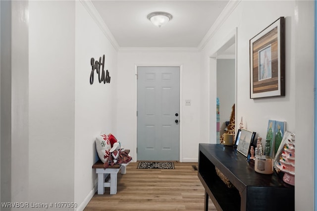 foyer entrance featuring light wood-type flooring and crown molding