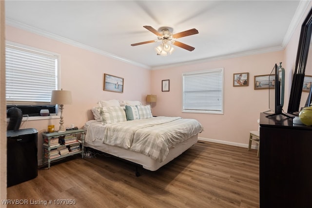 bedroom with ceiling fan, dark hardwood / wood-style flooring, and ornamental molding